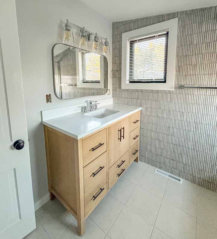 Finished bathroom remodel with modern tile and fixtures 